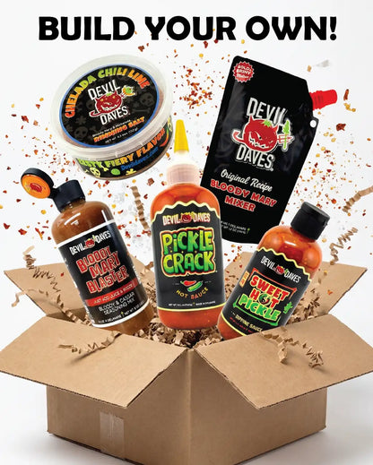 Assorted Devil Daves hot sauce and bloody mary products in an open cardboard box with 'Build Your Own bloody mary bundle' text above.
