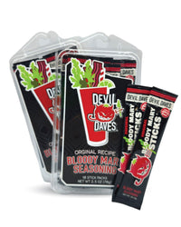 Packaging of Devil Daves Bloody Mary Seasoning Stick Packs with a display of the product, a shaker, and a garnish on top. The packaging is predominantly black with red and white accents, and includes the text 'Original Recipe Bloody Mary Seasoning'.