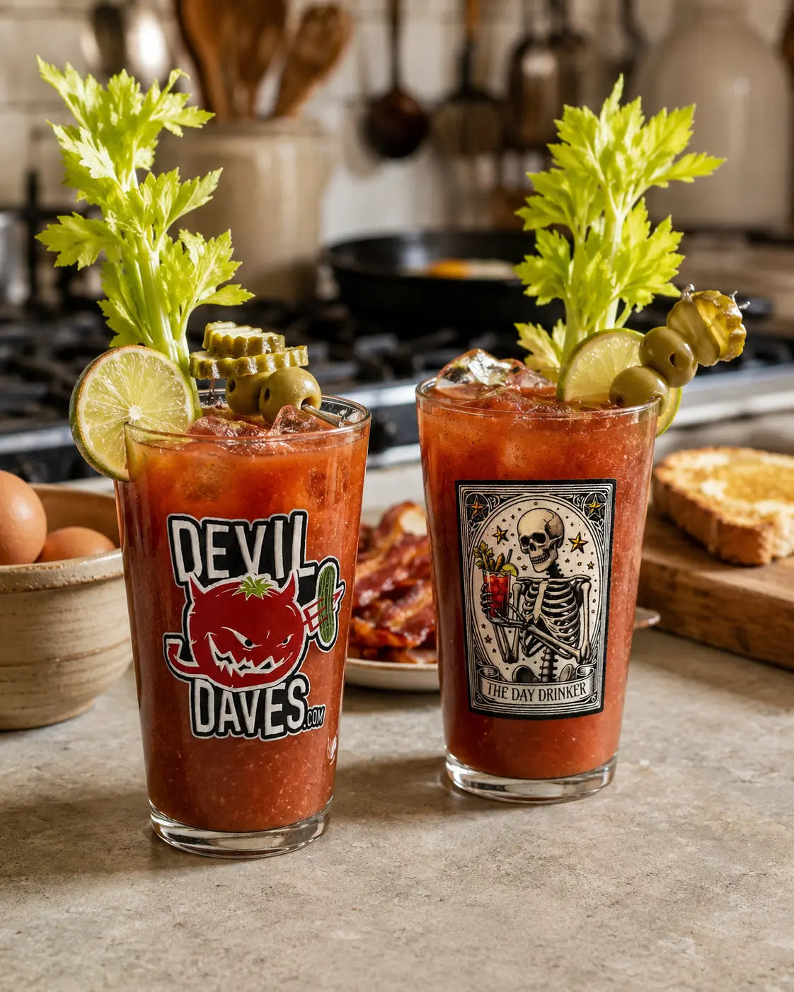 Two Bloody Mary cocktails with garnishes on a kitchen counter, featuring 'Devil Dave's' branding.